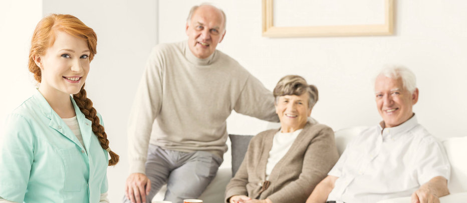 female caregiver with three senior people smling