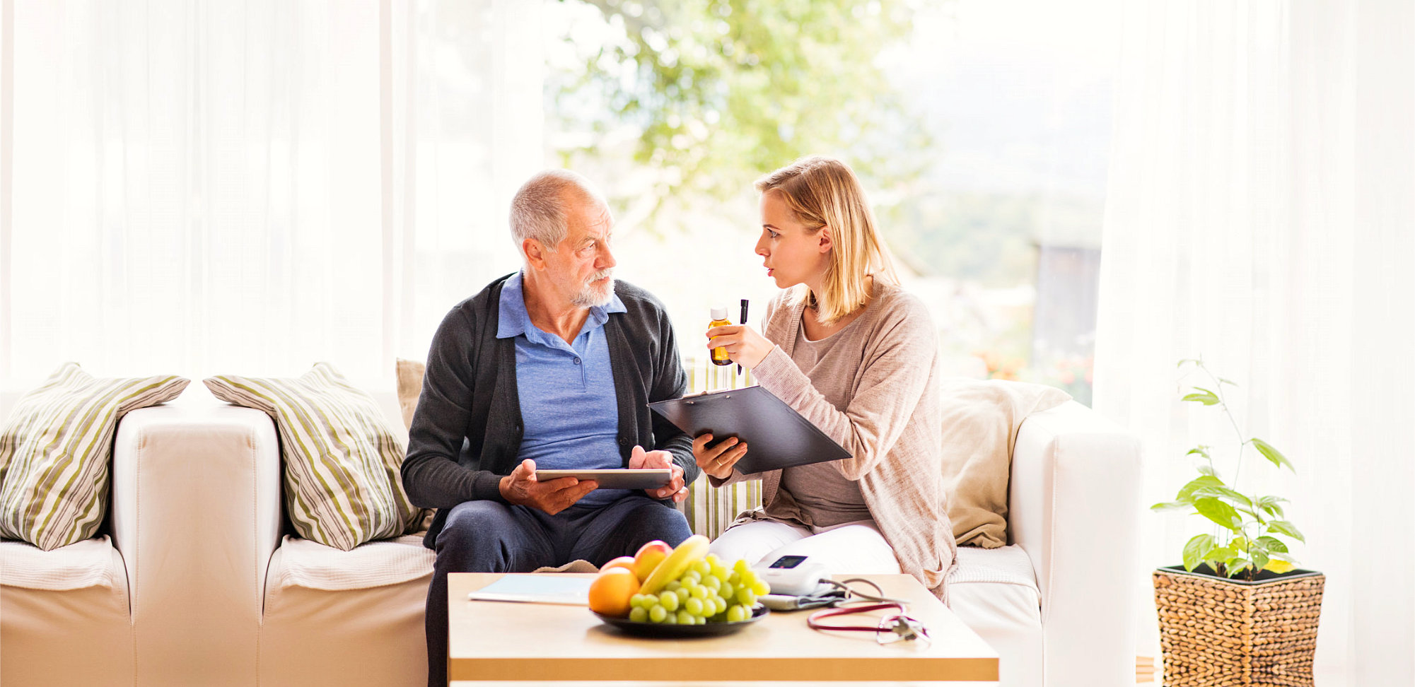 female caregiver having conversation with senior man