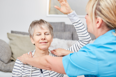 senior woman having occupational therapy with female therapist